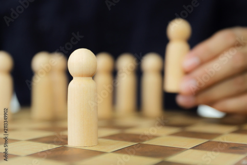 Person wooden doll standing leader from group teamwork people for HR human resources officer or business planning relationship or team player and personnel management job performance.
