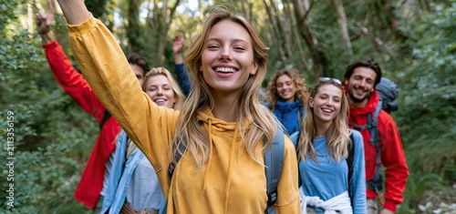 Cheerful hikers explore a sunny forest trail, enjoying vibrant greenery and the spirit of outdoor adventure together.