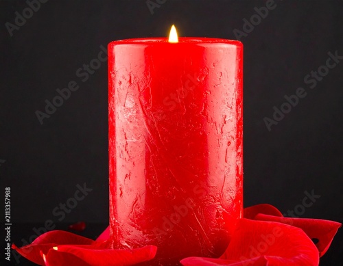 red candle on black background