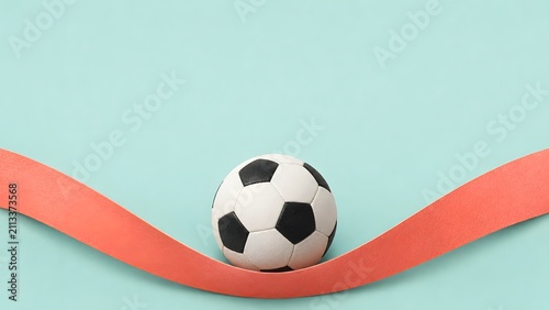 sports women's football 2026 Women’s Africa Cup of Nations football balanced on curved red ribbon against mint background for tournament momentum and performance concept

