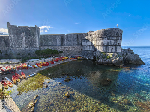 Fort Bokar in Dubrovnik Croatia with colorful kayaks on the pebble beach by the Adriatic Sea
