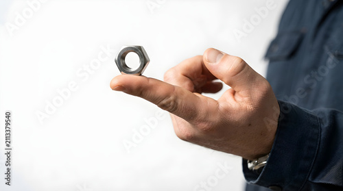 industrial worker holding steel hex nut isolated on white background