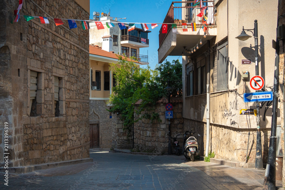 Fototapeta premium Narrow stone street with traffic signs in Kaleici old town Antalya Turkey