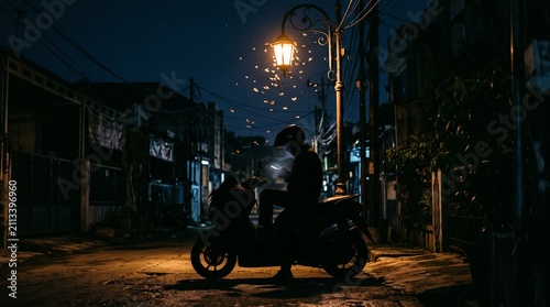 Silhouette of a motorcyclist parked under a glowing street lamp at night in a dark alley