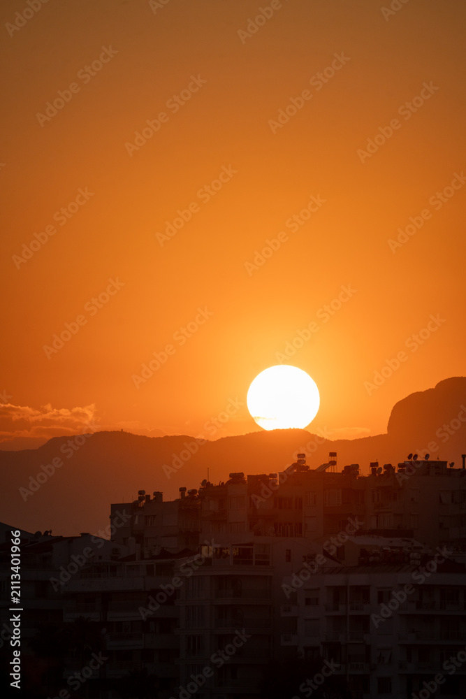 Fototapeta premium Vertical sunset view over Antalya city skyline and Taurus mountains Turkey