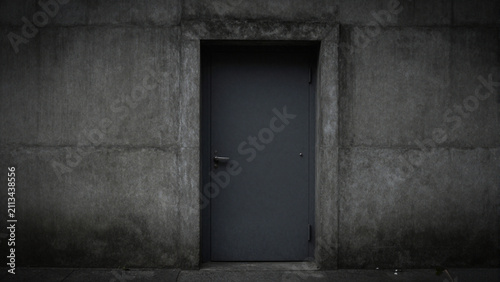 a closed minimalist concrete door with dark ambience