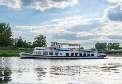 Obraz na płótnie White passenger excursion boat sailing along the Vistula River in Krakow, Poland