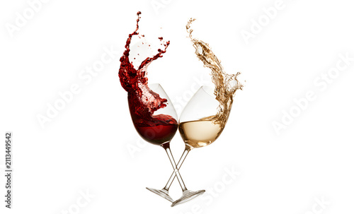 Crossed wine glasses with red and white wine splashes.
