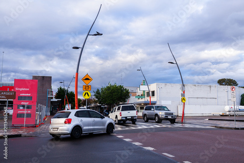 Cars crossing pedestrian crossing speed hump beside intersection