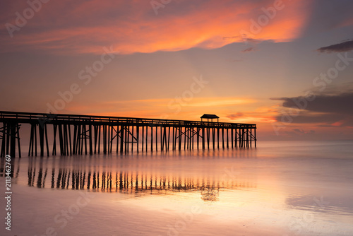 Obraz na plátně Sunset over a fishing pier