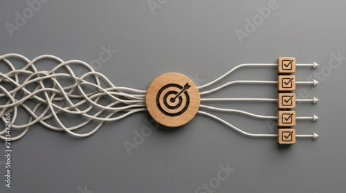 A wooden target icon with an arrow shot through it, surrounded by tangled white strings that converge and then straighten into five separate paths, each ending in a wooden cube with a checkmark