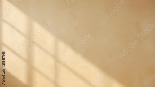 Soft natural sunlight casts a distinct rectangular window frame shadow across a smooth beige wall surface with elegant minimalist texture