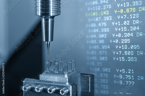 Abstract scene of a CNC milling machine cutting an electrode part with a ball nose end mill and G-code data background.