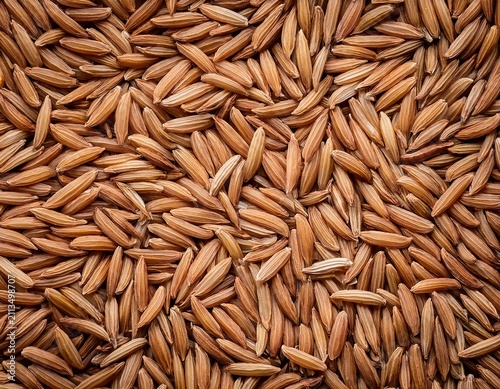 close up of rice bran forming a textured repeating pattern brown texture background