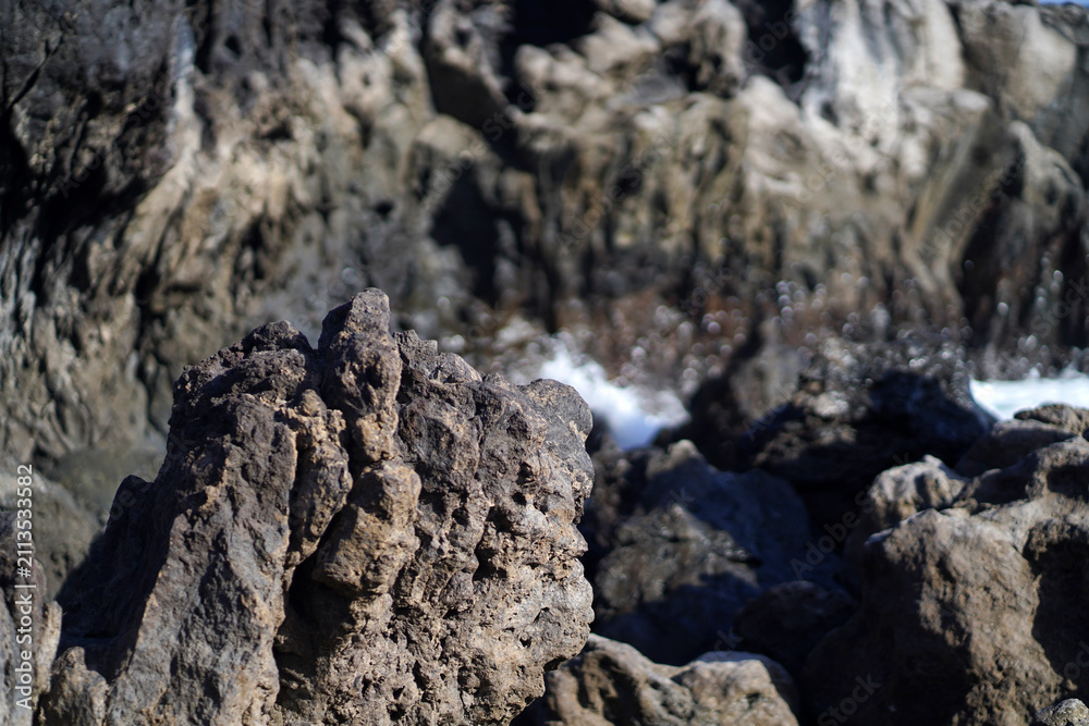 Obraz premium Black lava formations, basalt rocks closeup at the foot of a volcano.