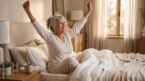Senior Latina woman enjoying a gentle morning stretch in a cozy bedroom with natural sunrise light.