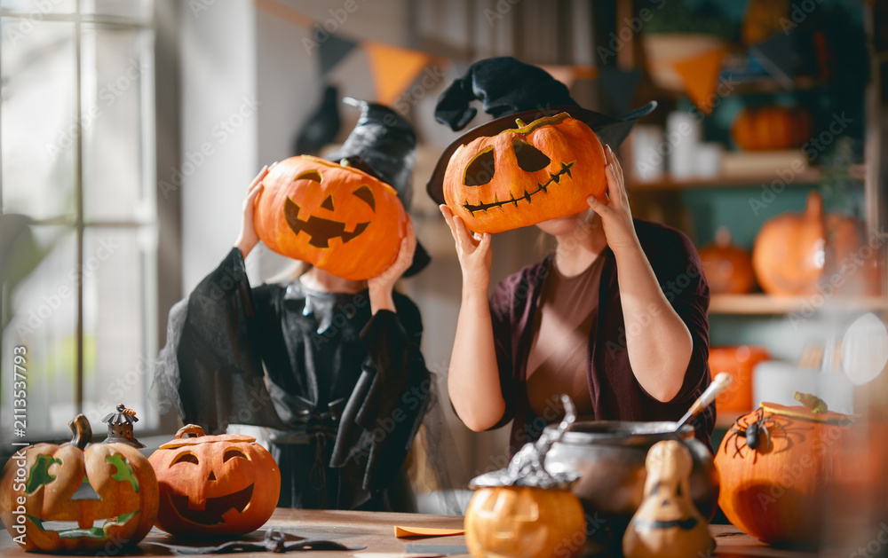 © Konstantin Yuganov - Funny Halloween Family Moments, Mother and Daughter with Carved © Konstantin Yuganov - Funny Halloween Family Moments, Mother and Daughter with Carved