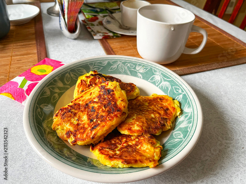 Homemade Vegetarian Fried Vegetable Flour Pancakes with Cabbage in Plate on White Table.