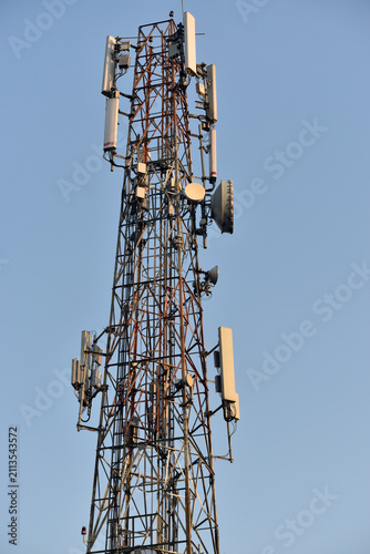 Base station transceiver tower against clear blue sky background