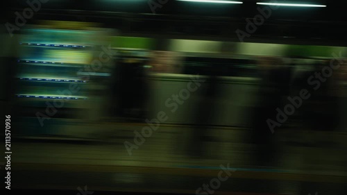 Subway train leaving station platform at night