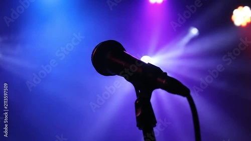 Stage Microphone Silhouette with Dramatic Blue and Purple Spotlights