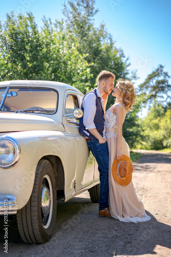 фотографія Young Boho Couple Love Story by a Retro Car