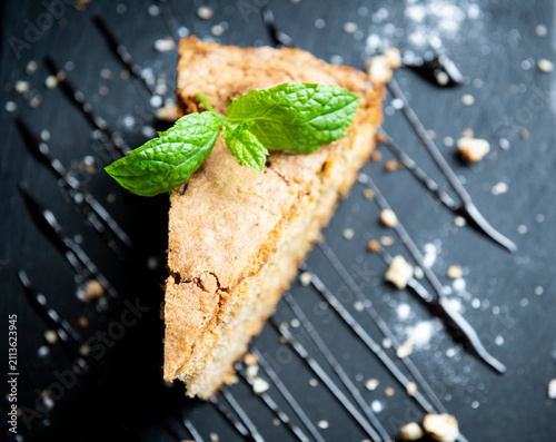 Slice of Homemade Cake with Mint Decoration