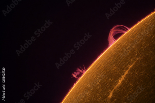 Solar prominences looping on sun edge, stellar activity and astronomy.