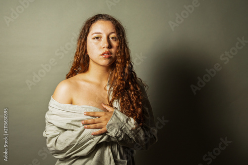 Woman expressing vulnerability with hands on chest