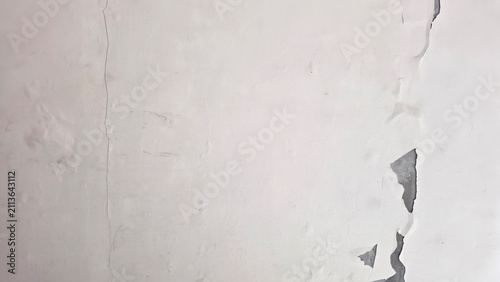 Photography Weathered wall with peeling paint, damp stains, cracks, and deteriorated plaster, showing moisture damage, aging surface, decay, and building maintenance or renovation problems