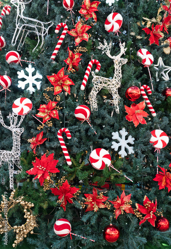 Christmas tree decorated with candy canes, poinsettias and reindeer ornaments