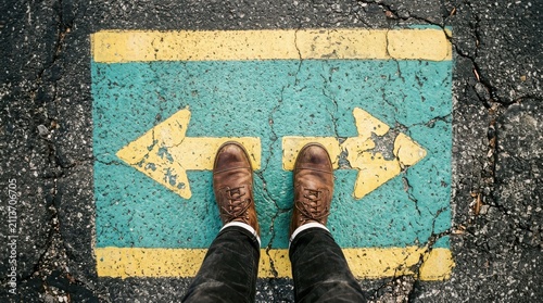 Person standing between two arrows pointing in opposite directions