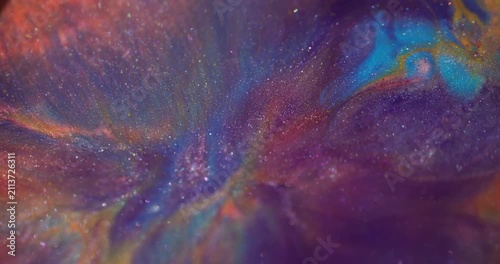 Shimmering spill blur. Ink blend. Purple blue pigment fluid swirling on glitter particles colorful texture on abstract background.
