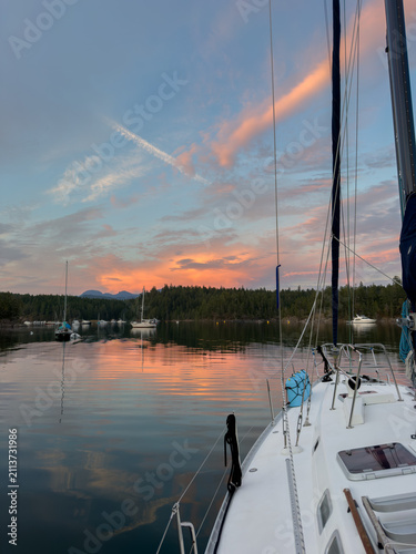 View from a sailboat of the sunset from an anchorage