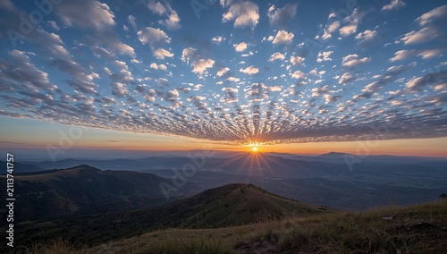 Plakat w ramie Breathtaking sunrise over mountain range with dramatic altocumulus clouds.