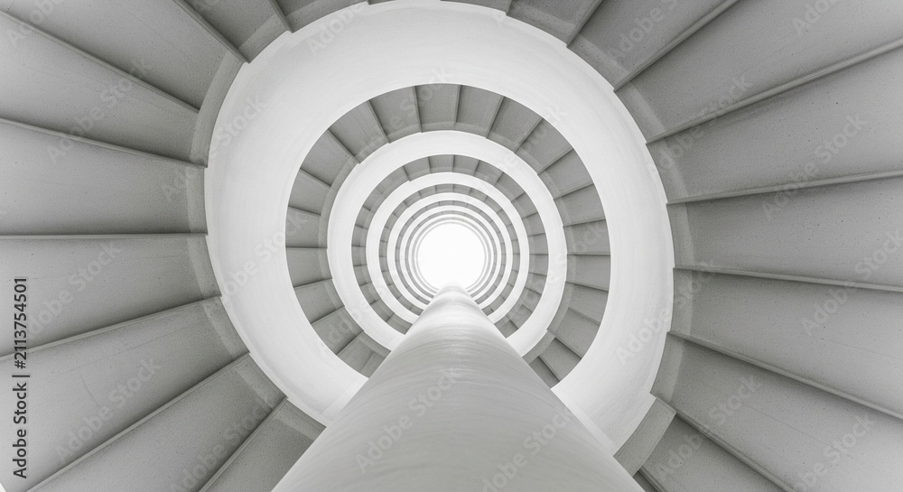 Fototapeta premium Looking up from the bottom of a white spiral staircase towards a bright circular skylight at the top