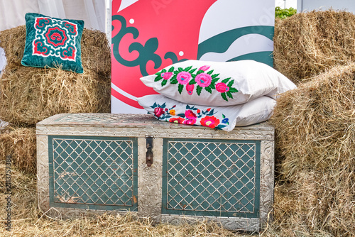 Ethnic Tatar Photo Zone Decoration with Vintage Trunk, Embroidered Pillows and Hay Bales