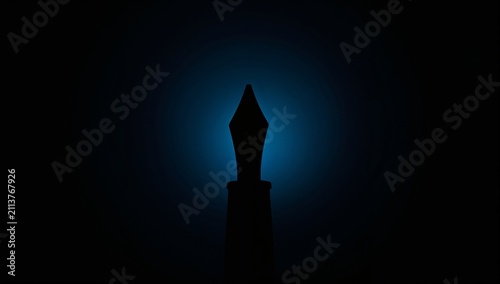 Fountain Pen Silhouette With Blue Lighting in a Dark Space