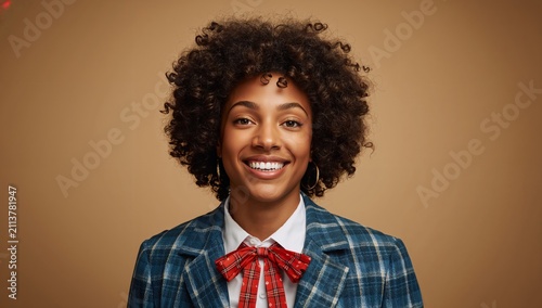 Smiling Person With Curly Hair in a Blue Checked Suit and Red Bow Tie