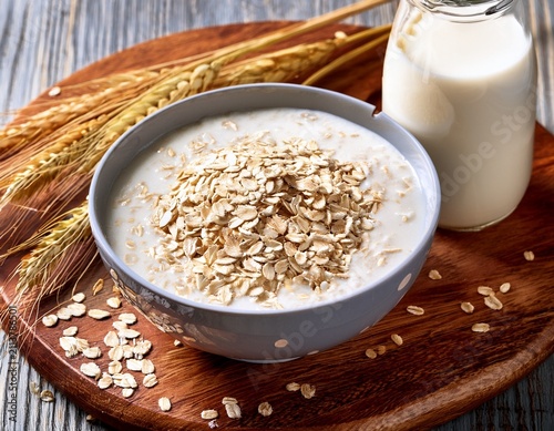oatmeal and oat milk on wooden board