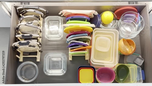 Top View of colorful kitchen drawer filled with various food storage containers