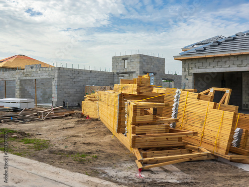 Konstfotografi Stacks of prefabricated wooden roof trusses for assemblage on bare concrete shel