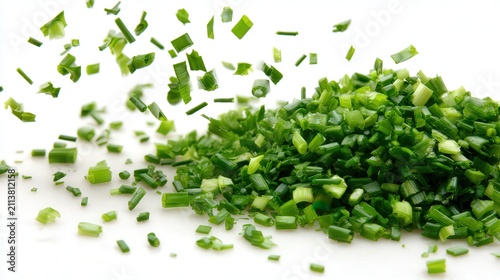 Freshly chopped green herbs scatter artistically over a white background, ideal for culinary articles, recipe books, and food blogs, This vibrant image symbolizes freshness and flavor enhancement,