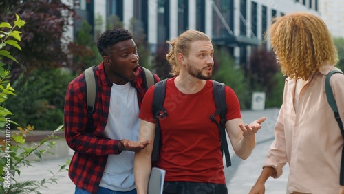 Bild auf Leinwand Group three multiethnic students talking emotional arguing smiling emotive discu