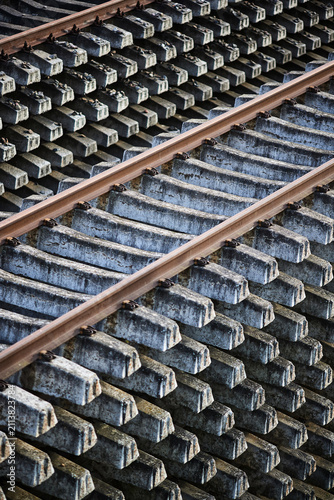 Quadro su tela Railway track with concrete sleepers industrial infrastructure transportation materials close up