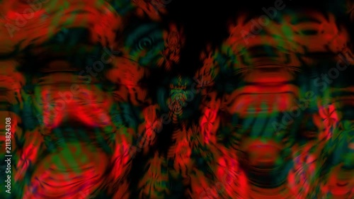 Vibrant red and green abstract shapes blur across dark background. Motion creates swirling
