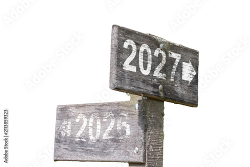 A rustic wooden sign marking the New Year 2027, with 2026 worn away.