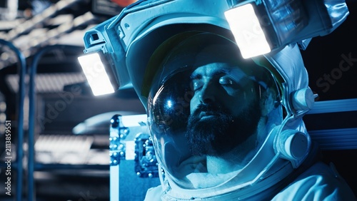 Burnout cosmonaut feels the emotional toll of isolation inside a silent orbital station, staring blankly across the spacecraft cockpit after a long mission and prolonged confinement far from Earth.