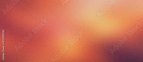 Fotografie Warm orange gradient background with grainy texture, soft amber light leak effect on dark red surface