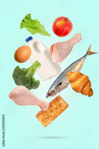 Levitation healthy Food Collection with Fresh Fruits, Vegetables, Dairy, Fish, Bread, and Poultry Isolated on light green Background